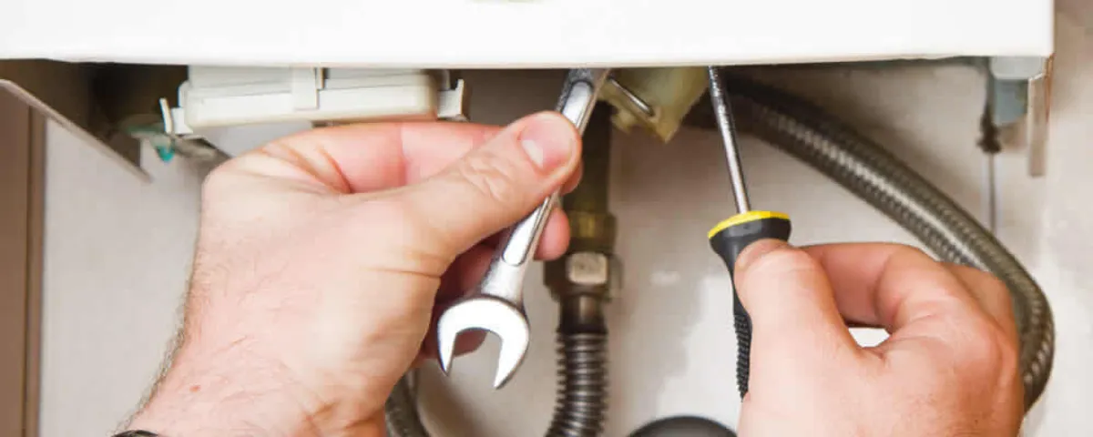 Boiler repair technician tightening pipe fittings and connections in Allen, TX