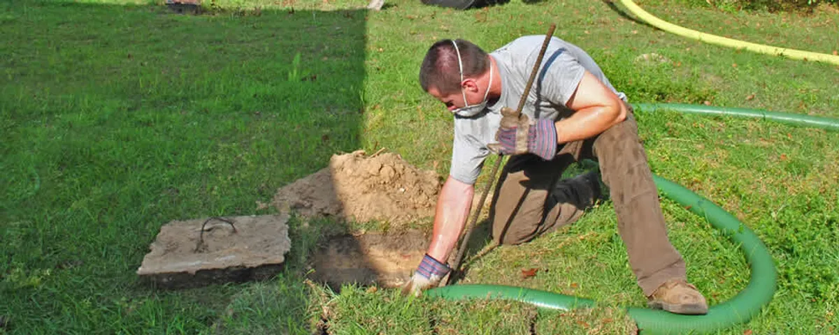 Septic pumping technician servicing a residential septic tank in Allen, TX