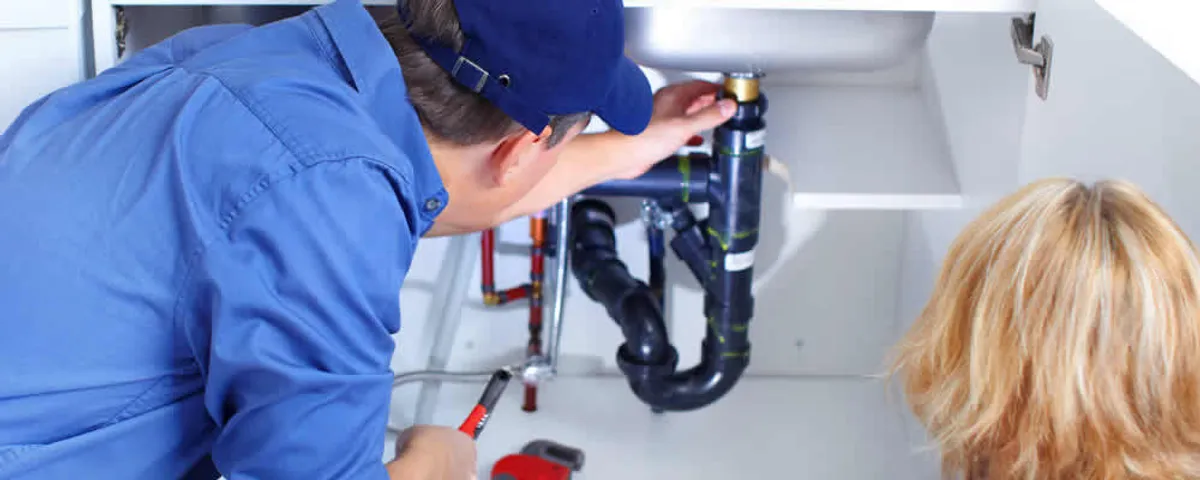 Plumber repairing under-sink drain pipes and fittings in Allen, TX